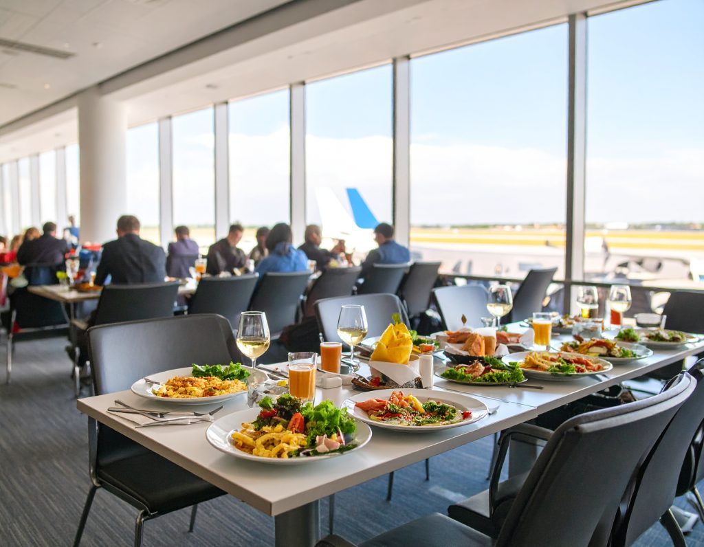 Qantas Business Class Lounge Interior with Travelers Relaxing - 2025