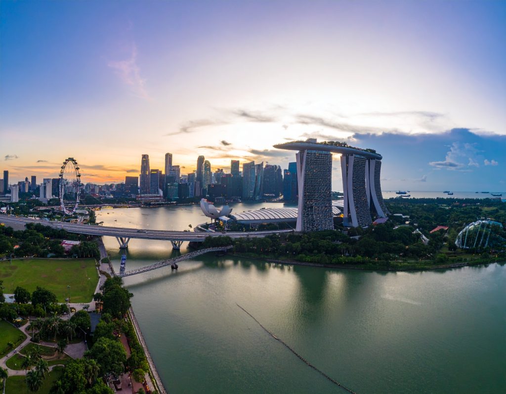 Panoramic view of Singapore from Marina Bay Sands SkyPark observation deck during sunset.