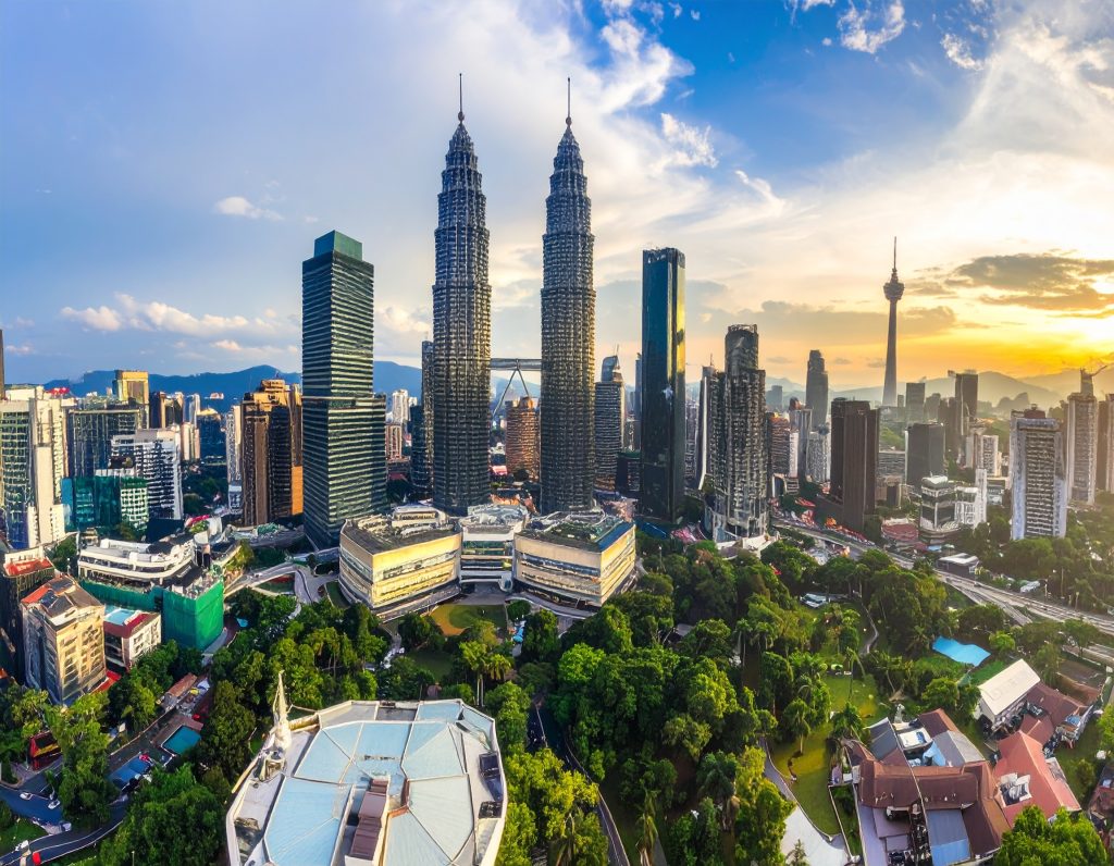 Petronas Twin Towers in Kuala Lumpur with clear blue sky – iconic Malaysia landmark.