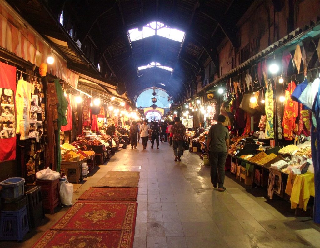 Petaling Street in Kuala Lumpur Chinatown with market stalls and red lanterns.