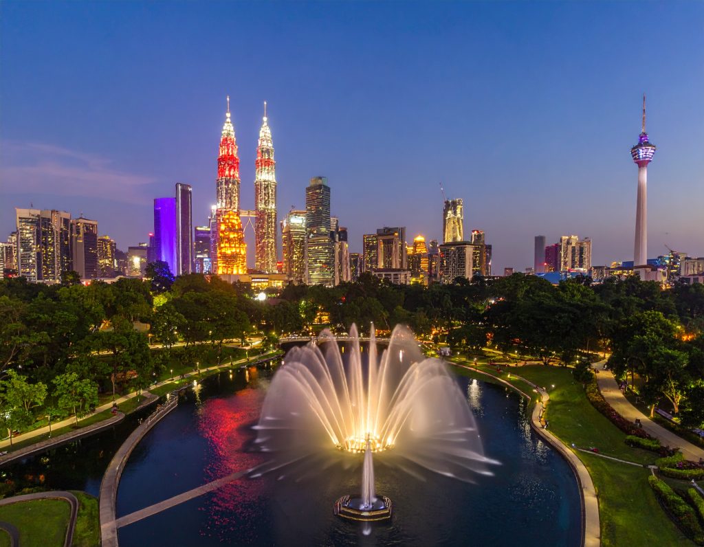 KLCC Park with water fountain and Petronas Towers in the background.