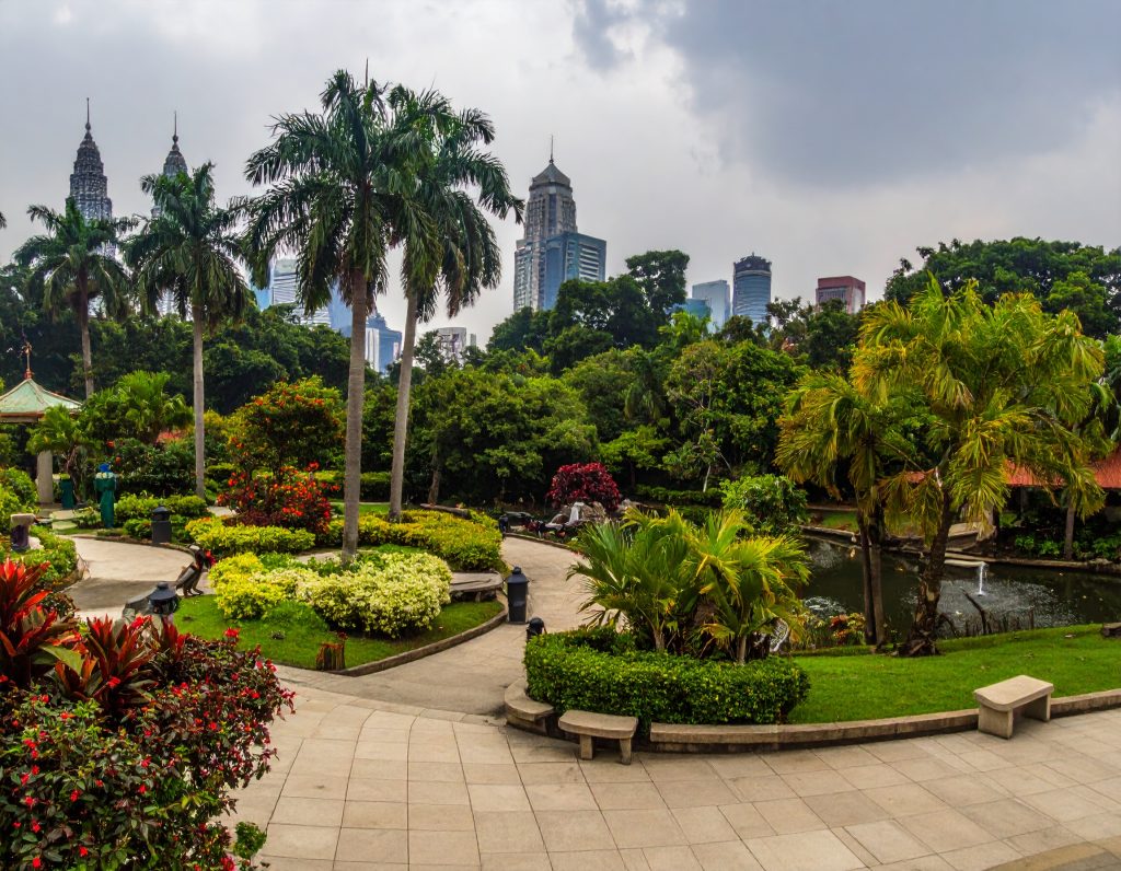 Scenic pathway surrounded by tropical plants in Perdana Botanical Gardens.