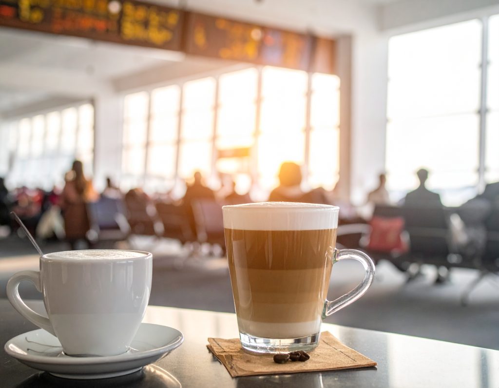 Barista serving coffee at Starbucks in an airport.