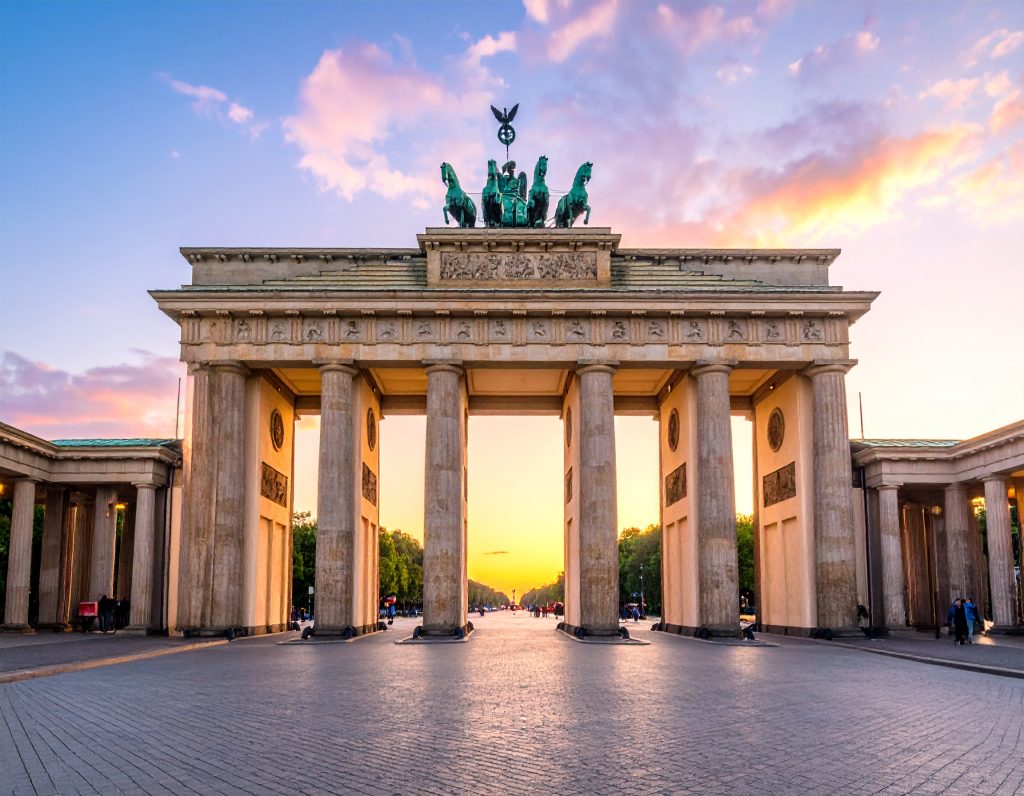 Brandenburg Gate in Berlin at sunrise with clear sky.