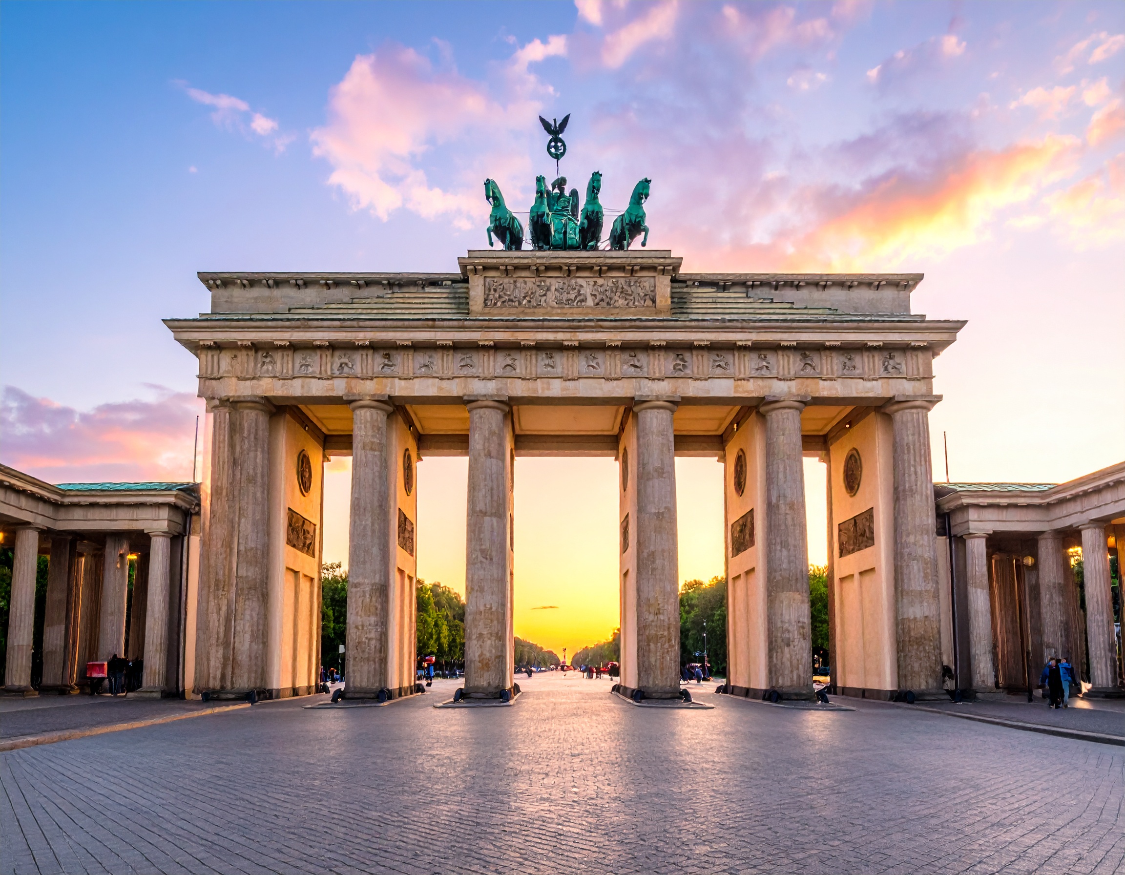 Brandenburg Gate in Berlin at sunrise with clear sky.