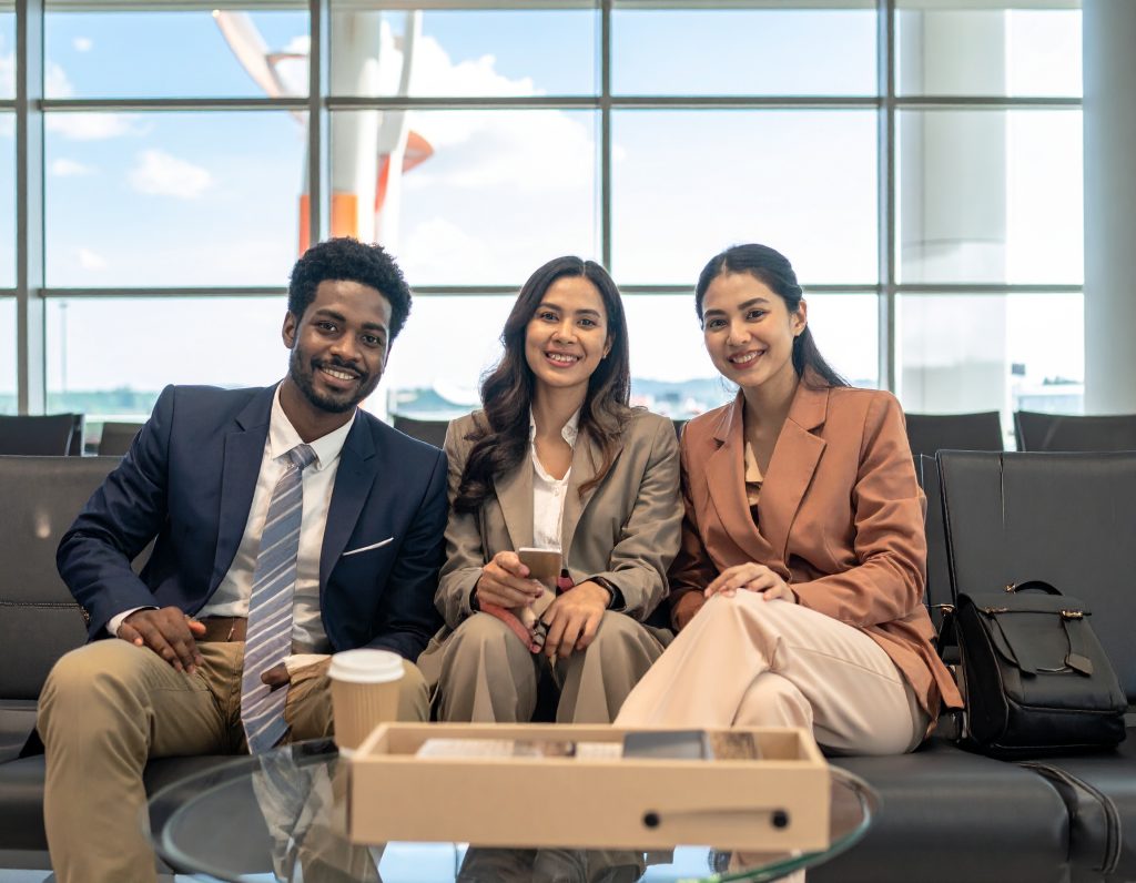 Business travellers relaxing in a modern airport lounge.