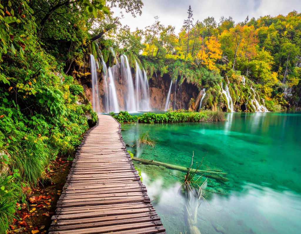 Turquoise waterfalls and wooden boardwalks at Plitvice Lakes.