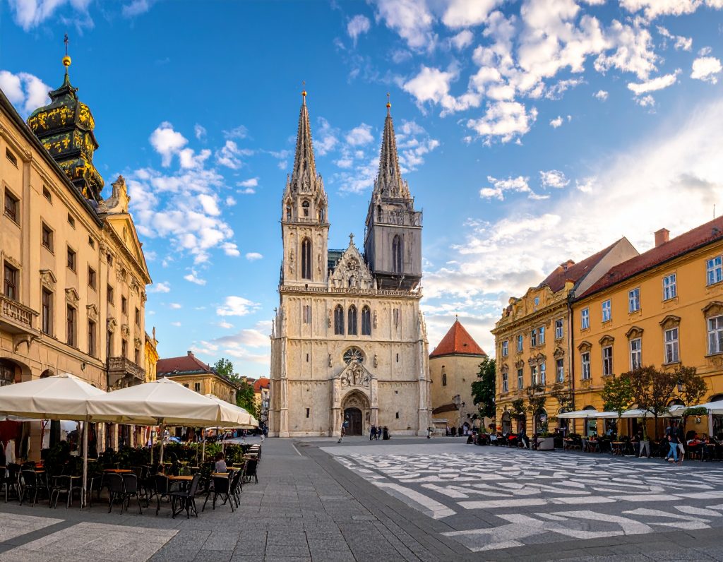 Zagreb city square with historic cathedral and cafes.