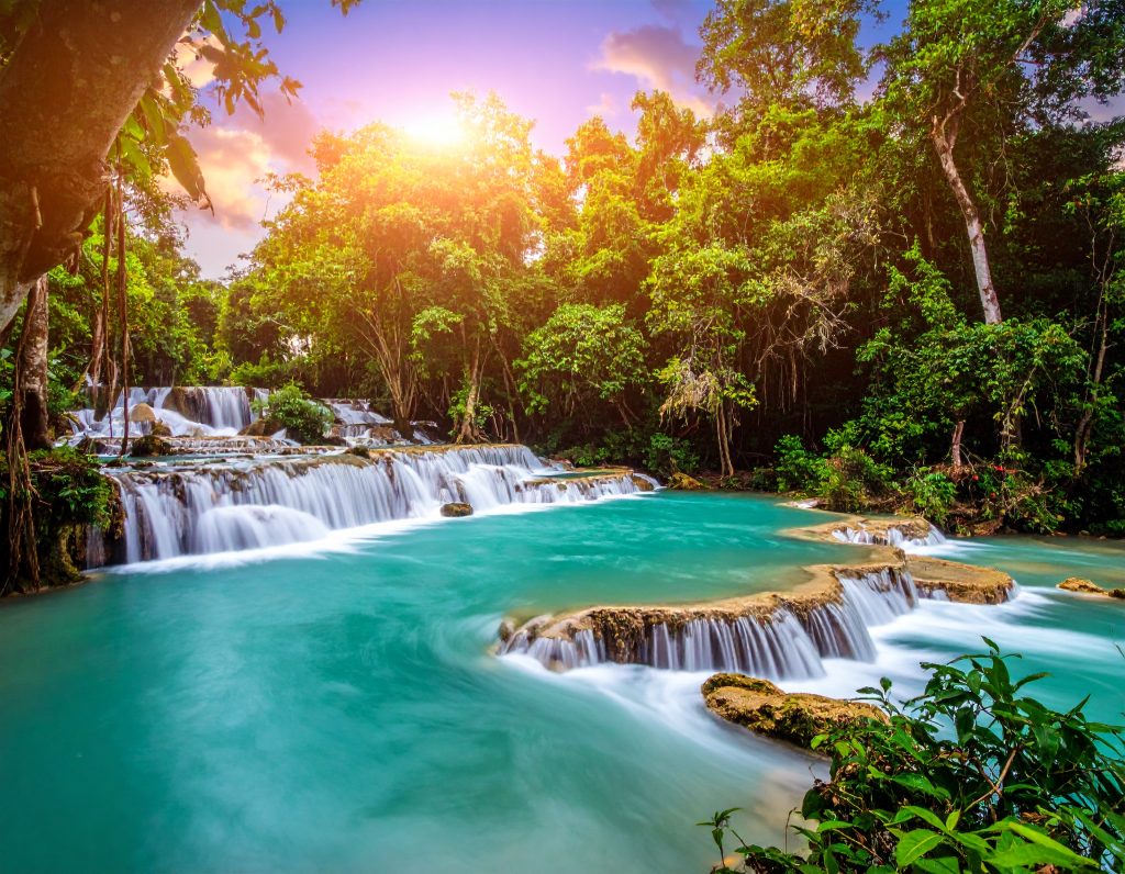 Kuang Si Falls with turquoise pools surrounded by lush jungle near Luang Prabang.