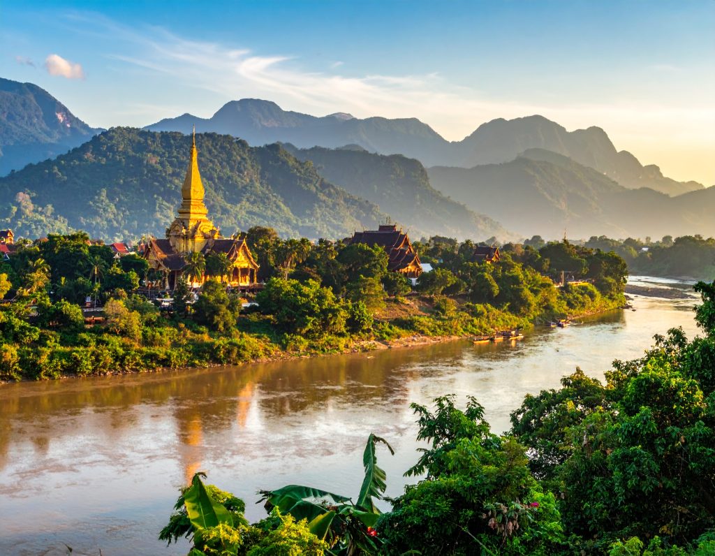 Luang Prabang city with temples along the Mekong River at sunset, Laos.