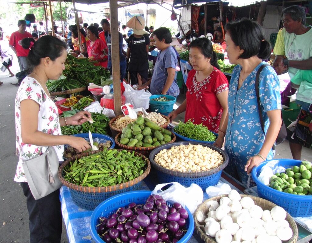 Colorful street market in Cambodia with local crafts and food stalls.