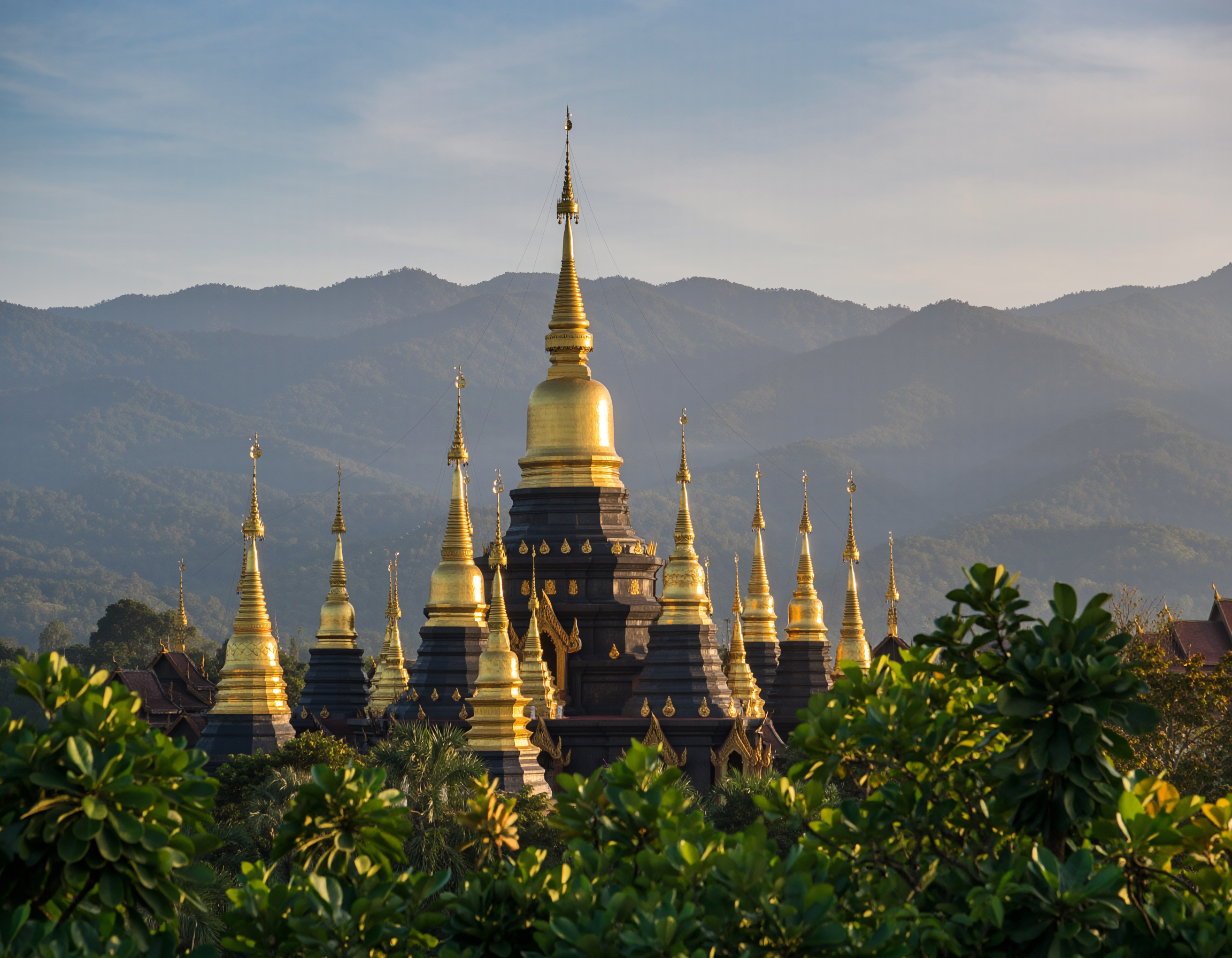 Aerial view of Chiang Mai city with Doi Suthep and golden temples.