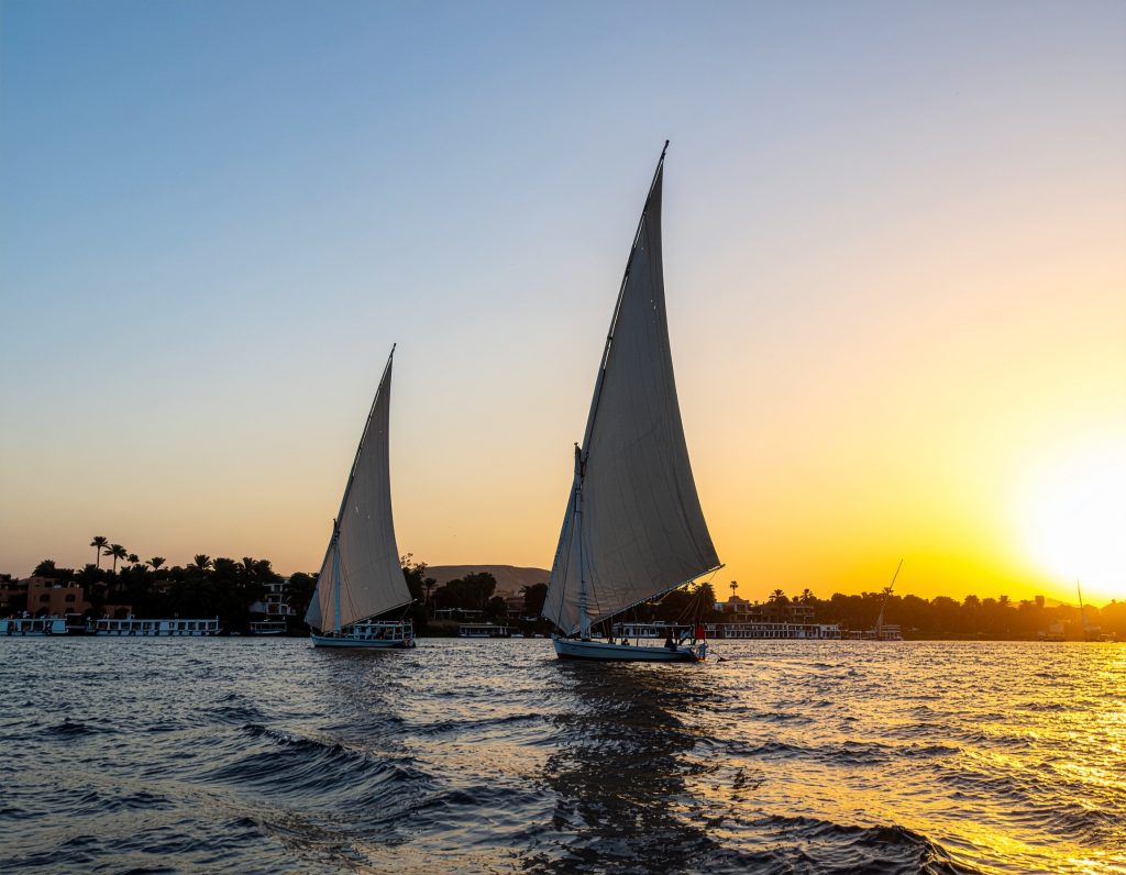 Traditional felucca boats sailing on the Nile River in Egypt.